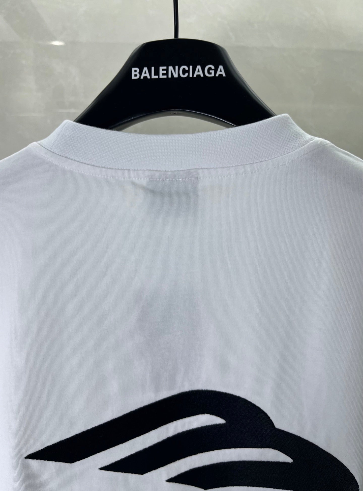 Balenciaga white T-shirt back view on hanger with large logo