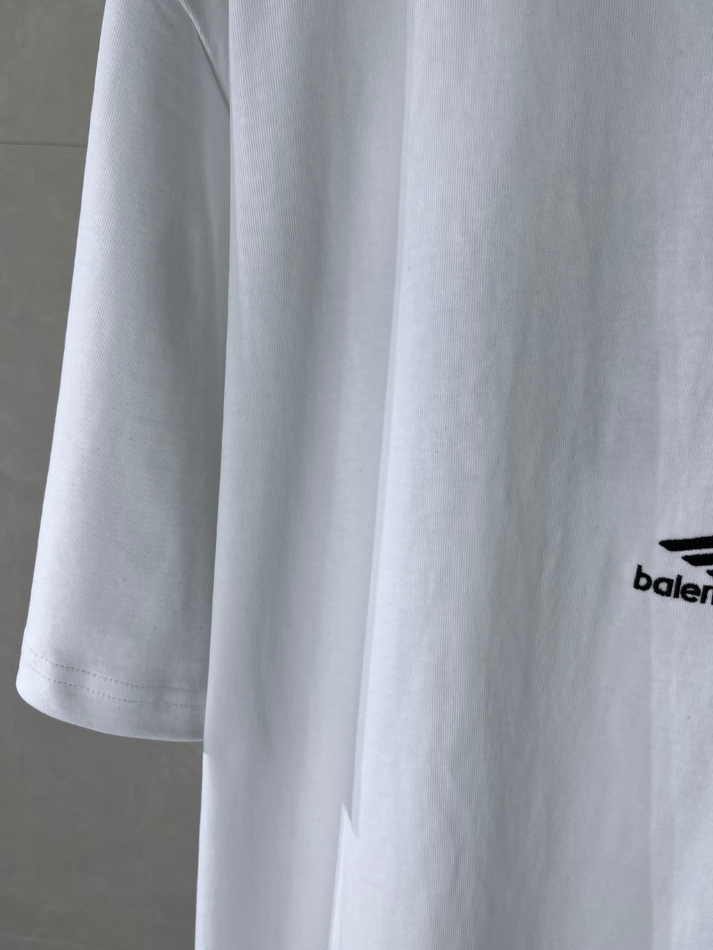 Balenciaga white T-shirt sleeve detail with partial side logo