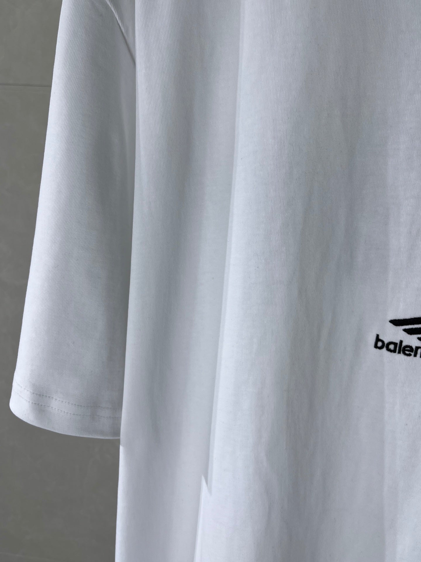 Balenciaga white T-shirt sleeve detail with partial side logo