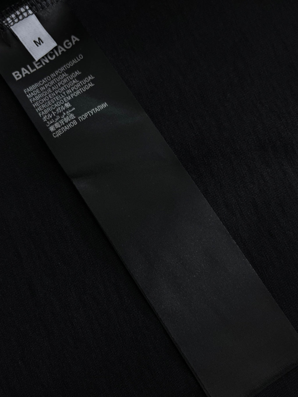 Balenciaga black T-shirt fabric label with size and care text on tag