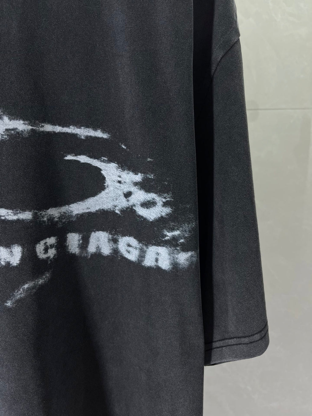 Balenciaga dark T-shirt with partial white graphic “RAVE” logo print