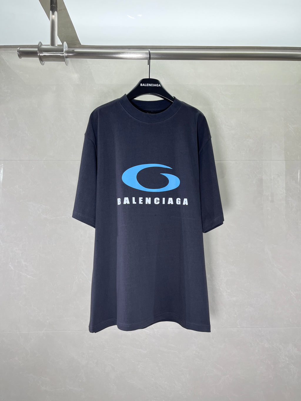Balenciaga dark graphic T-shirt with blue oval logo and BALENCIAGA text on chest