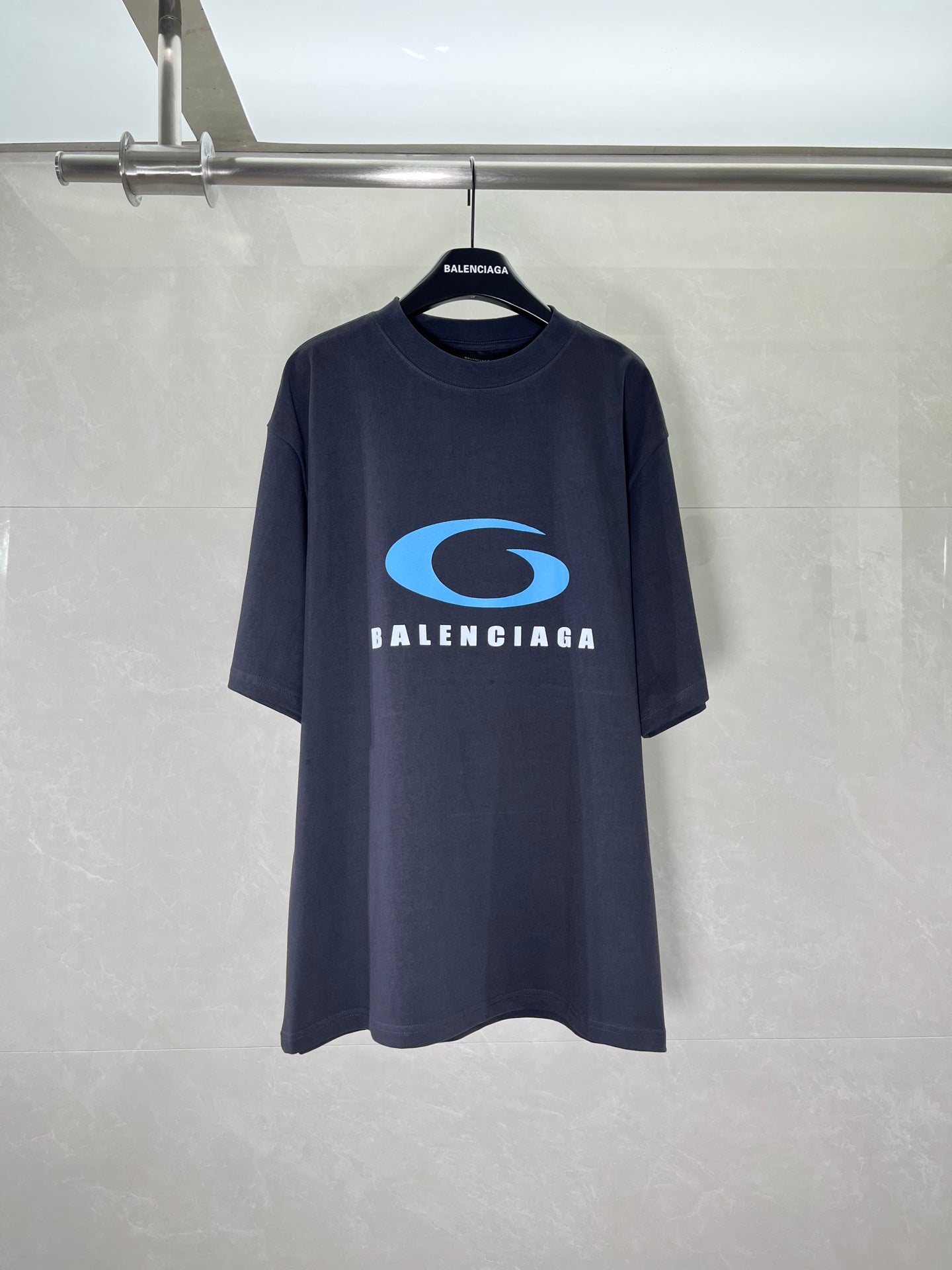 Balenciaga dark graphic T-shirt with blue oval logo and BALENCIAGA text on chest