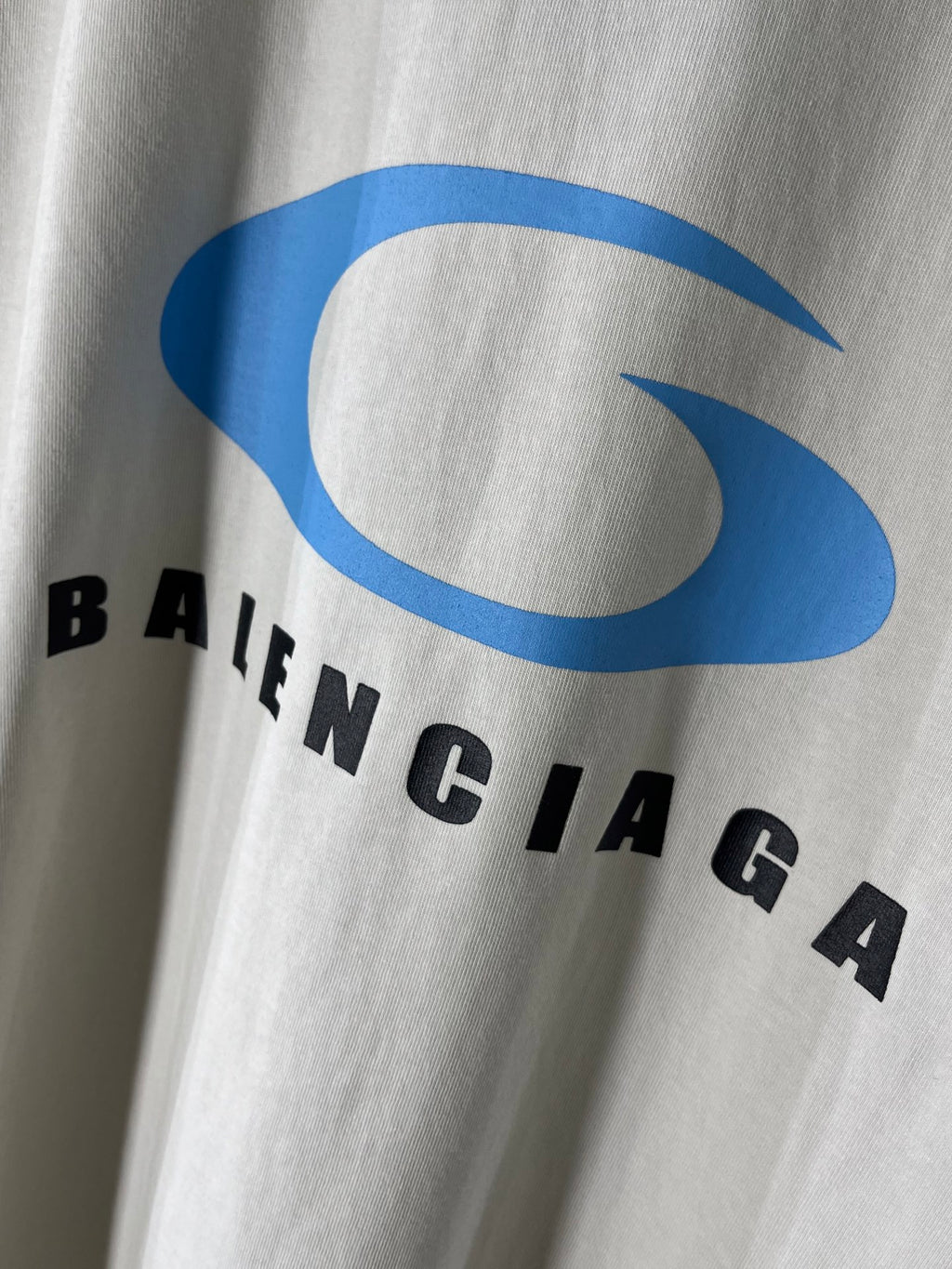 White T-shirt chest with large blue BALENCIAGA logo and black letters