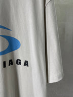 White T-shirt sleeve with partial blue and black BALENCIAGA logo lettering