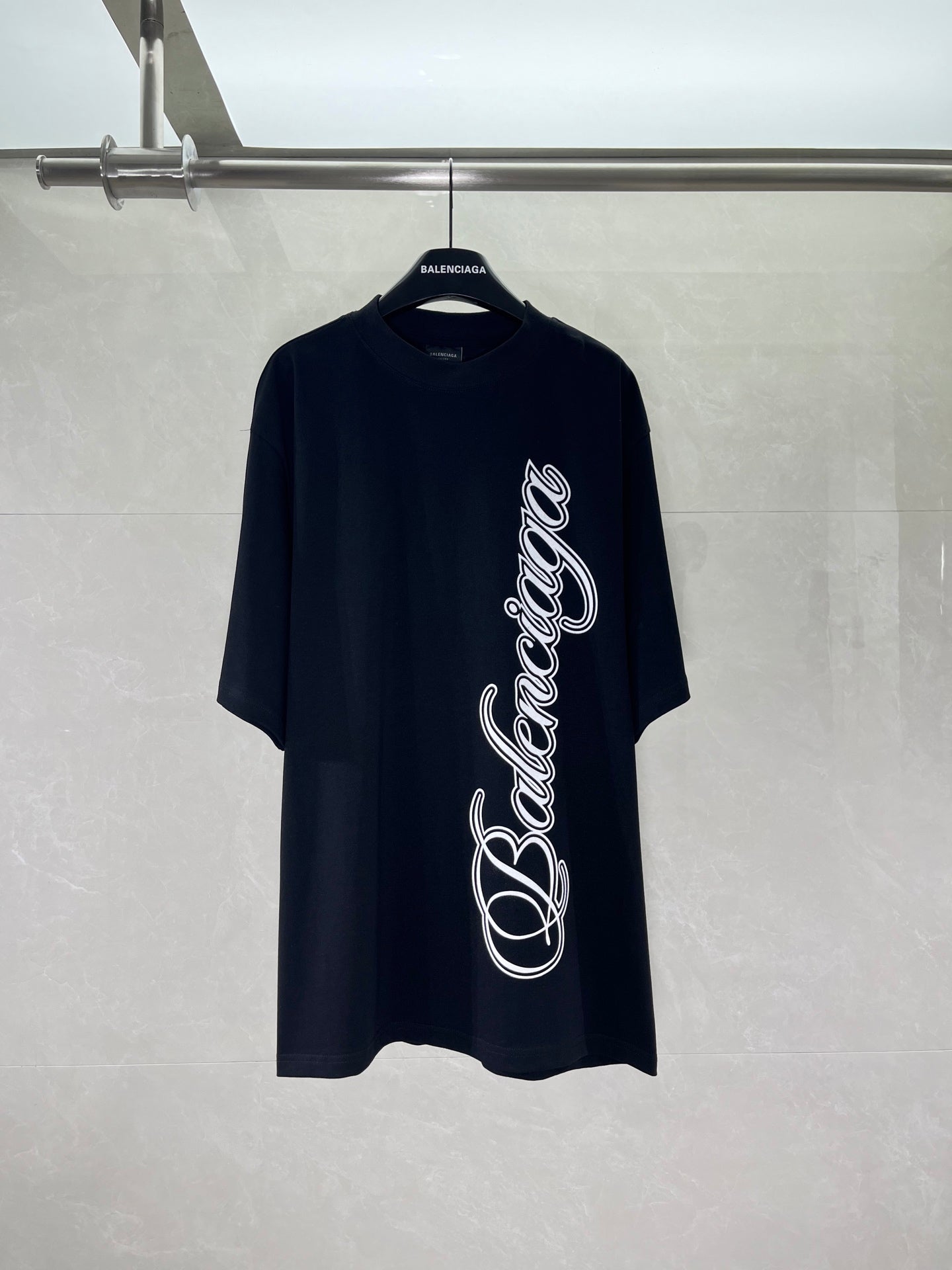 Balenciaga black T-shirt with large white script logo on the front