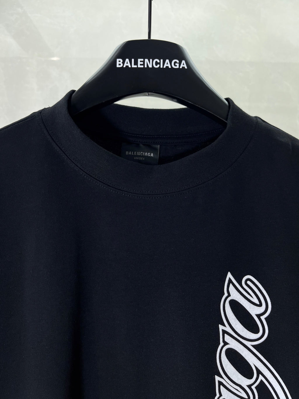 Balenciaga black T-shirt neckline and sleeve with white script logo print