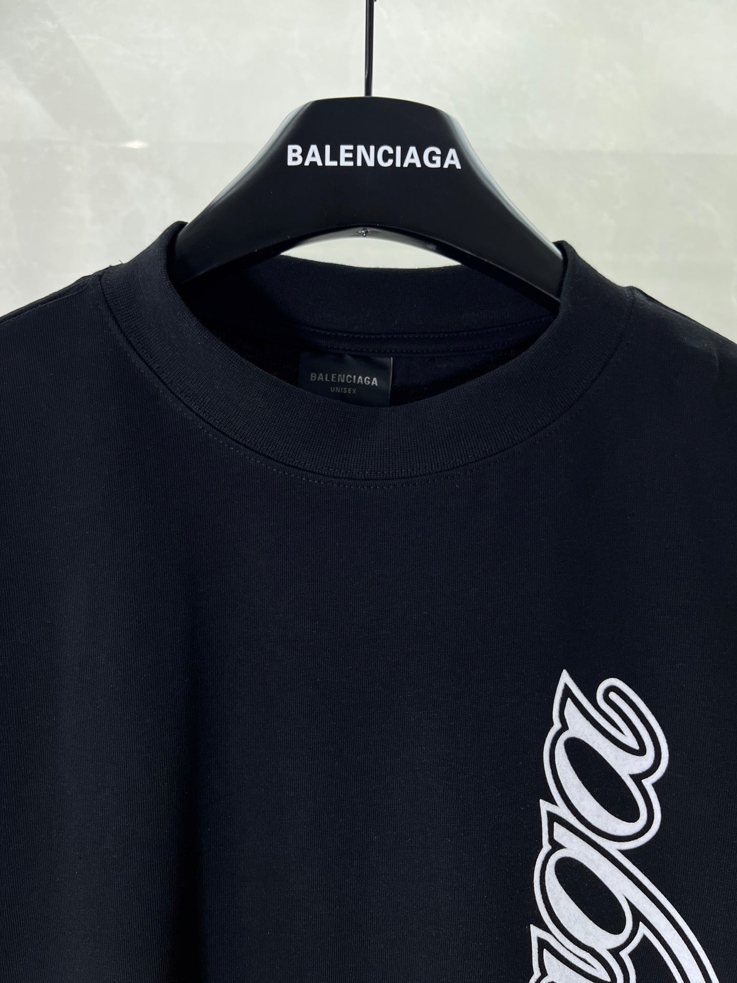 Balenciaga black T-shirt neckline and sleeve with white script logo print