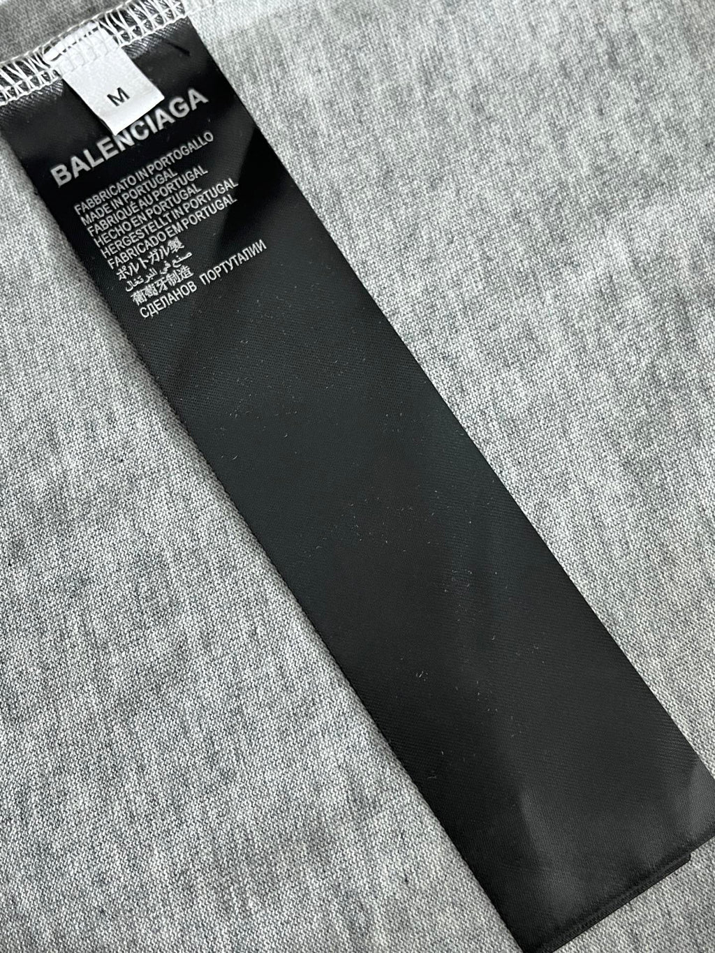 Heather gray T-shirt with black care label and size tag
