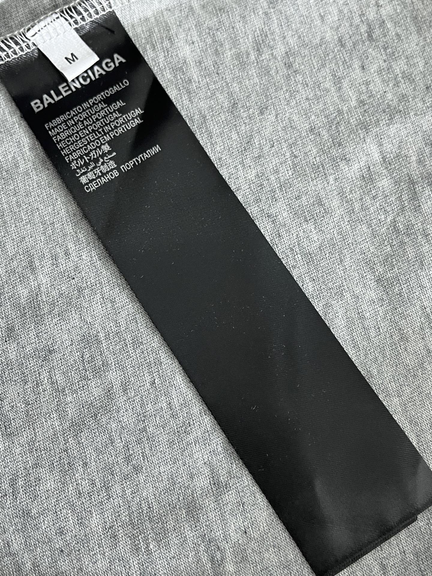 Heather gray T-shirt with black care label and size tag