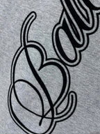 Heather gray T-shirt with black cursive and heart graphic detail
