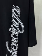 Balenciaga black T-shirt close-up of large white script wordmark graphic