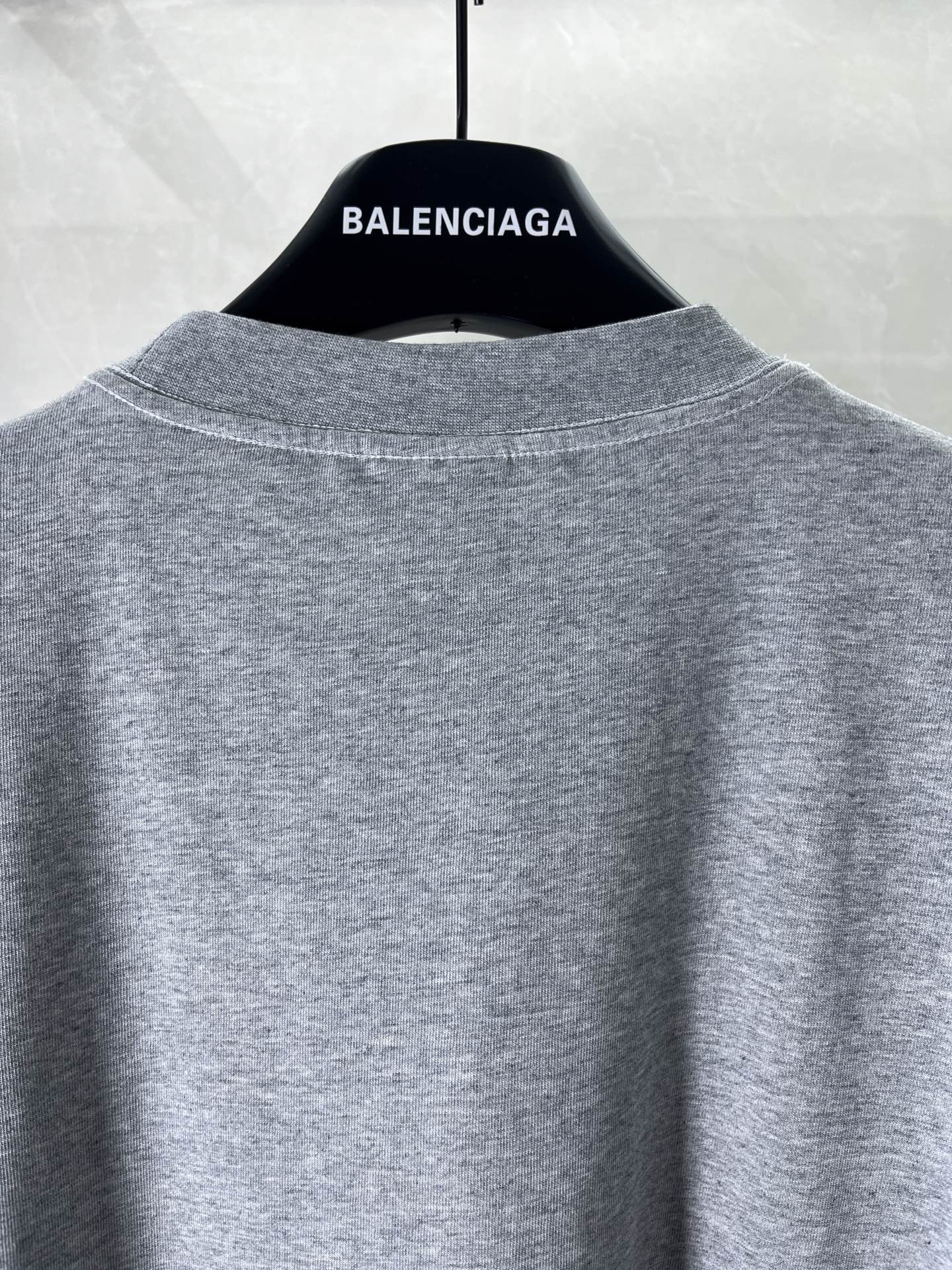 Heather gray crew-neck T-shirt back view, plain without graphics