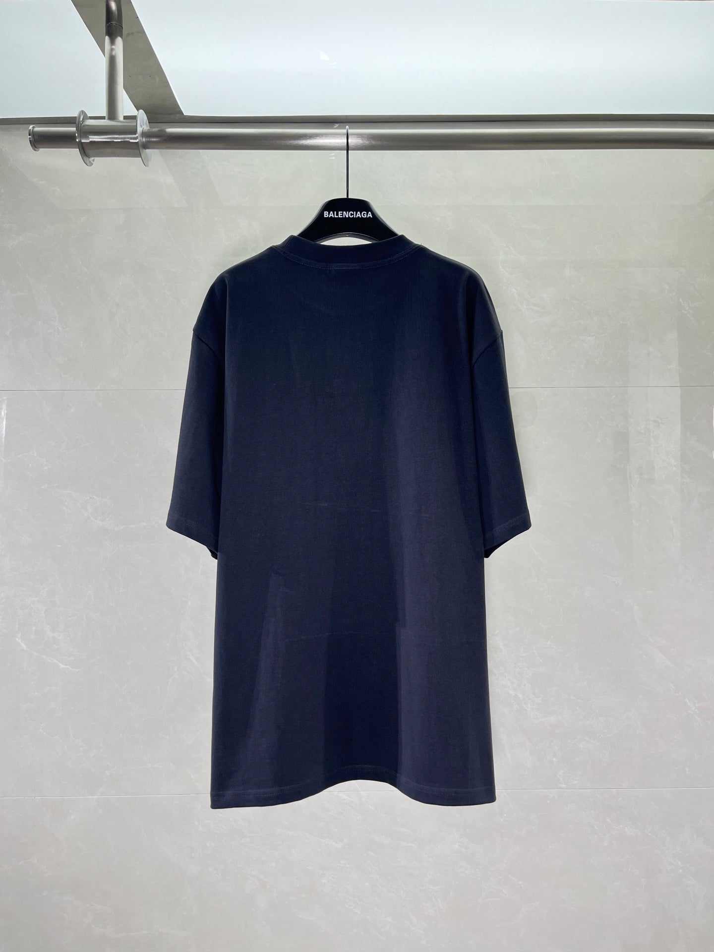 Navy short-sleeve crewneck T-shirt on hanger, plain back with subtle logo