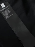 Black fabric care label on T-shirt tag with text and logo
