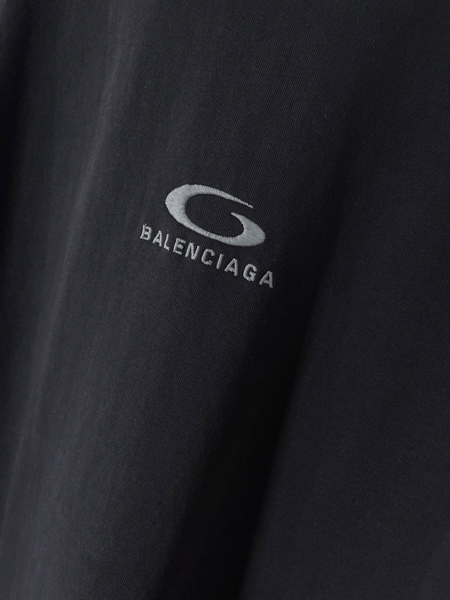 BALENCIAGA logo embroidery on dark T-shirt fabric