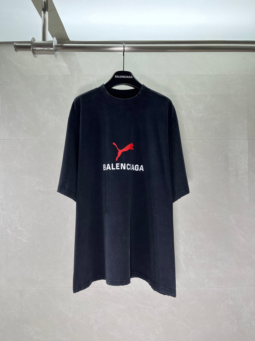 Dark navy short-sleeve T-shirt with red puma-style logo and BALENCIAGA chest print