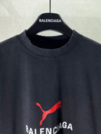Dark navy T-shirt neckline with red puma-style logo and BALENCIAGA text