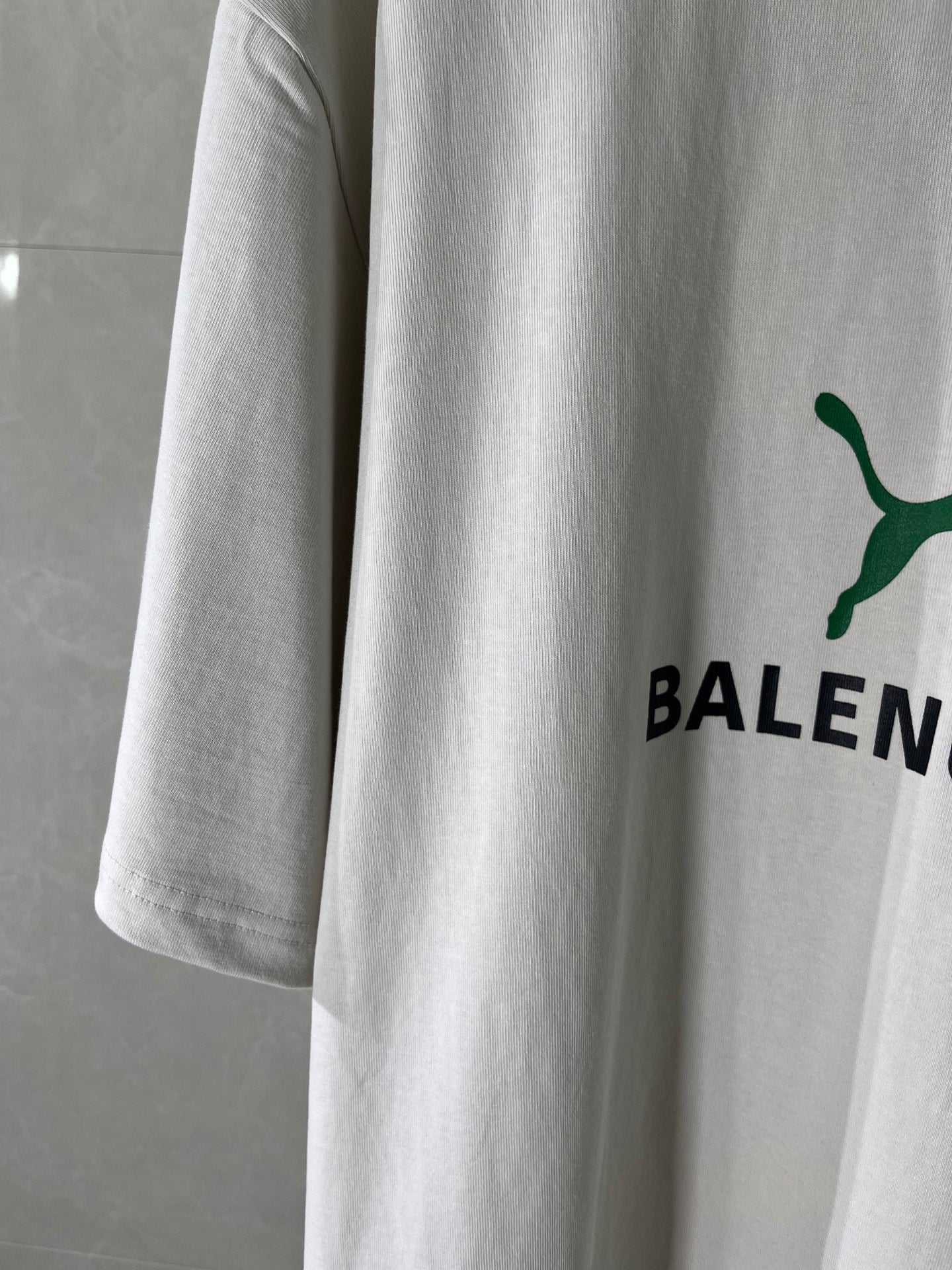White Balenciaga T-shirt side view with green puma and BALEN print