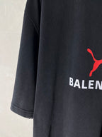 Dark navy short-sleeve T-shirt with partial red puma-style logo on the chest