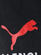 Dark navy T-shirt close-up of red puma-style logo
