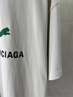 White Balenciaga T-shirt sleeve detail with green puma logo and CIAGA letters