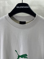 White Balenciaga T-shirt close-up: crew neck and green puma logo detail