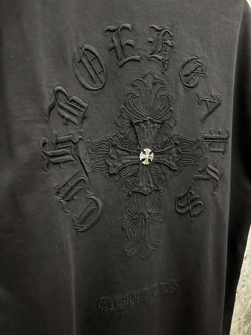 Black T-shirt back with embossed cross graphic embroidery and gold fleur-de-lis center.