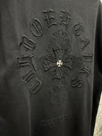 Black T-shirt back with embossed cross graphic embroidery and gold fleur-de-lis center.