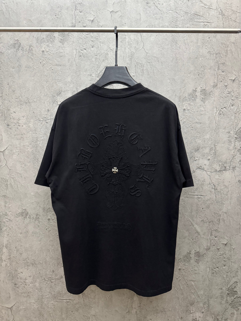Dark T-shirt with large back graphic emblem embroidery and crew neck.