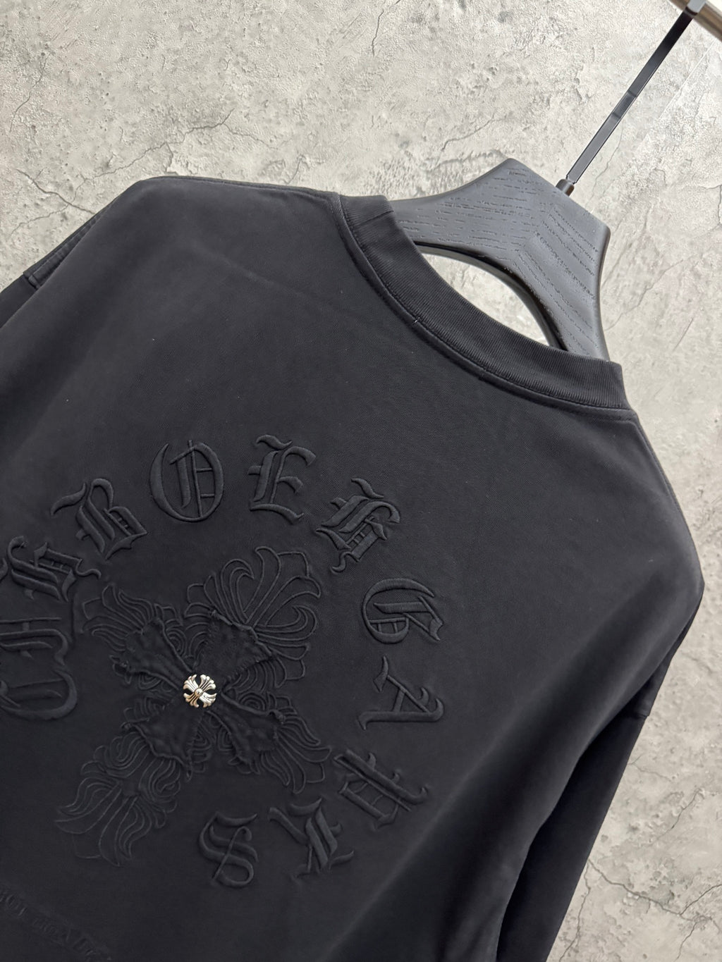 Black T-shirt back with raised cross emblem embroidery and crew neckline.