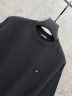 Black crew-neck T-shirt with embroidered chest emblem and interior neck label.