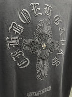 Dark gray T-shirt close-up of large cross emblem embroidery with gold accents