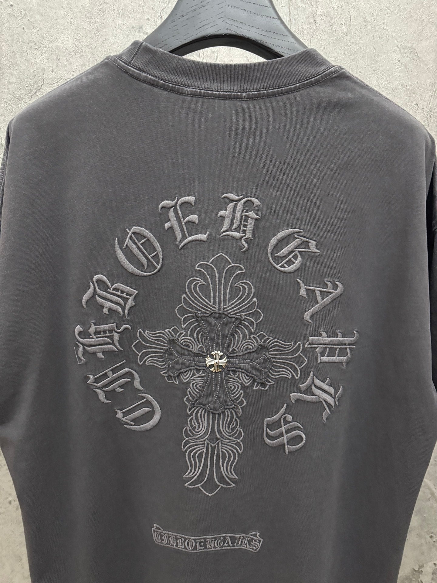 Dark gray crewneck T-shirt with large back cross emblem and small lower label