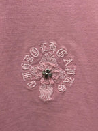 Close-up of light pink T-shirt fabric with embroidered floral design
