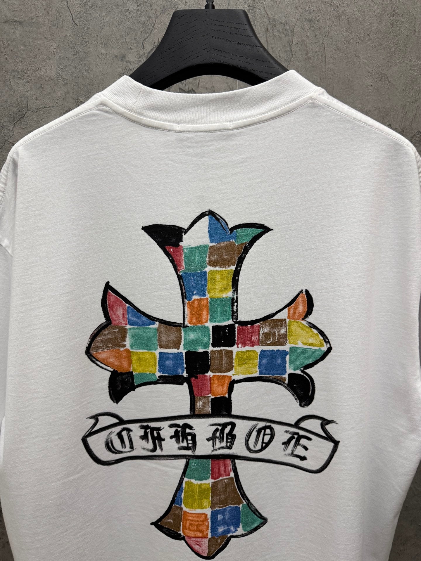 Back view white crewneck T-shirt with large colorful cross and banner graphic