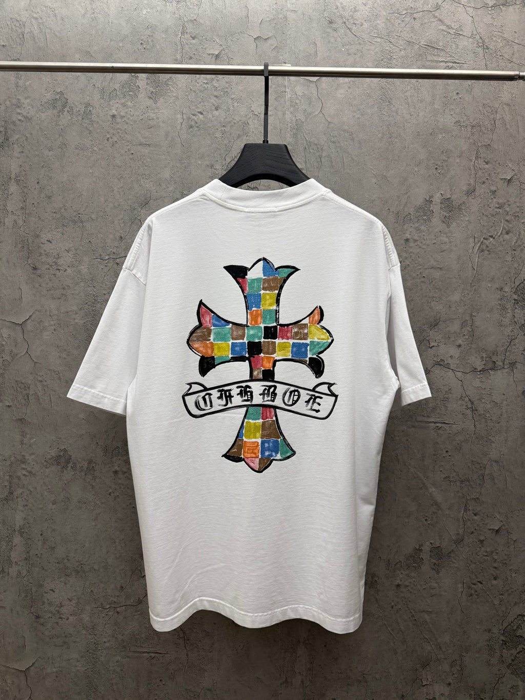 White crewneck T-shirt with large colorful cross graphic on the back