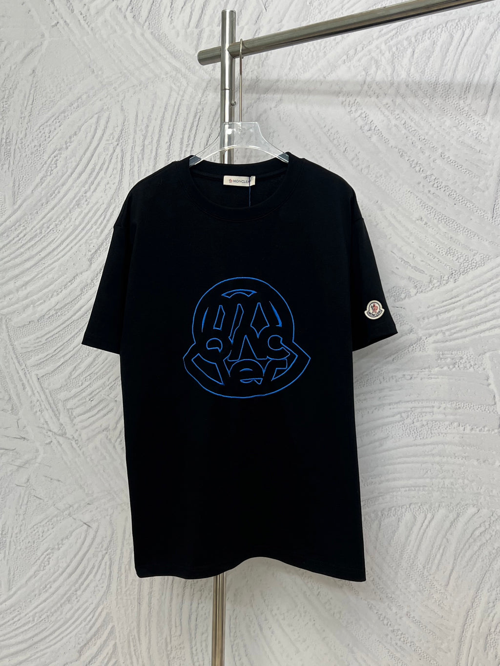 Black Moncler short-sleeve T-shirt with blue outline logo graphic