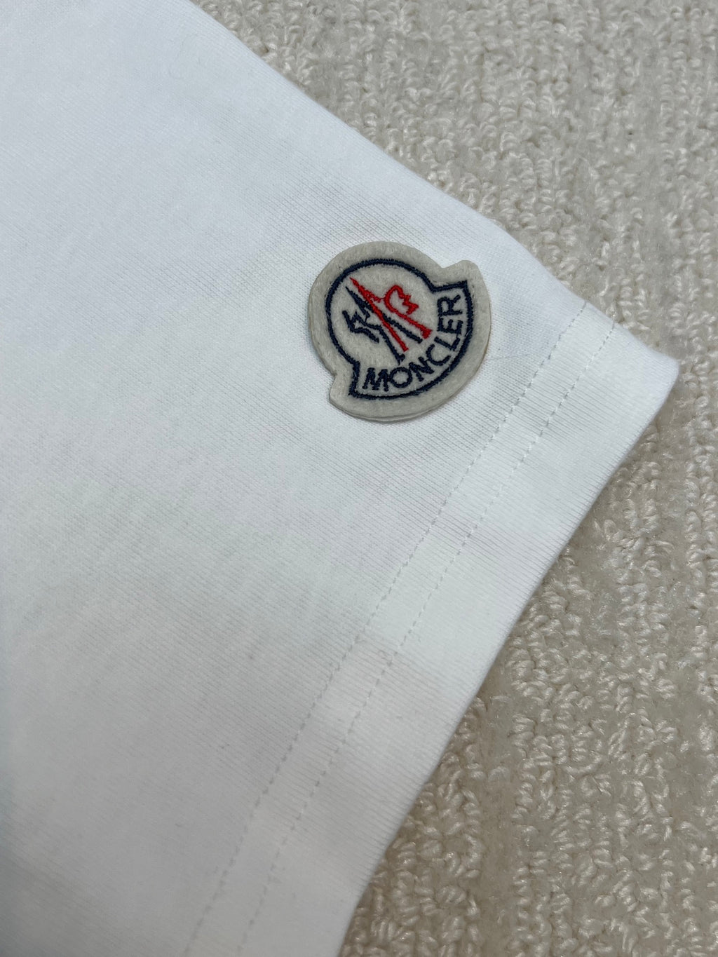 White T-shirt sleeve with Moncler logo patch