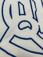 White T-shirt close-up of blue logo graphic
