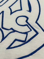 White T-shirt close-up of blue graphic embroidery