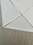 White T-shirt V-fold hem corner with visible seam stitching