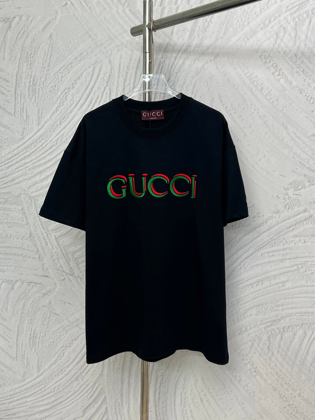 Black Gucci T-shirt with multicolor Gucci logo on the front