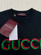 Black Gucci T-shirt with multicolor Gucci logo; round neckline close-up