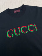 Black Gucci T-shirt with multicolor Gucci logo across the chest