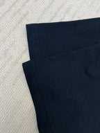 Black short-sleeve T-shirt fabric, seam lines visible