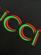 Black Gucci T-shirt close-up of green and red Gucci lettering