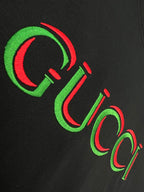 Black Gucci T-shirt close-up of multicolor Gucci lettering