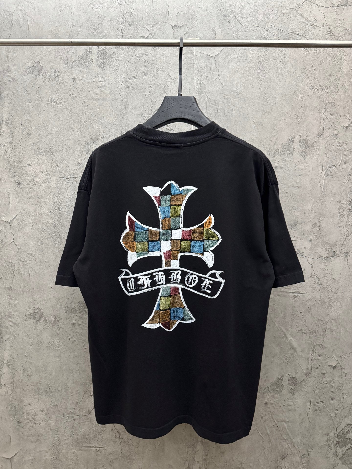 Black short-sleeve T-shirt with large back cross graphic and ribbon text