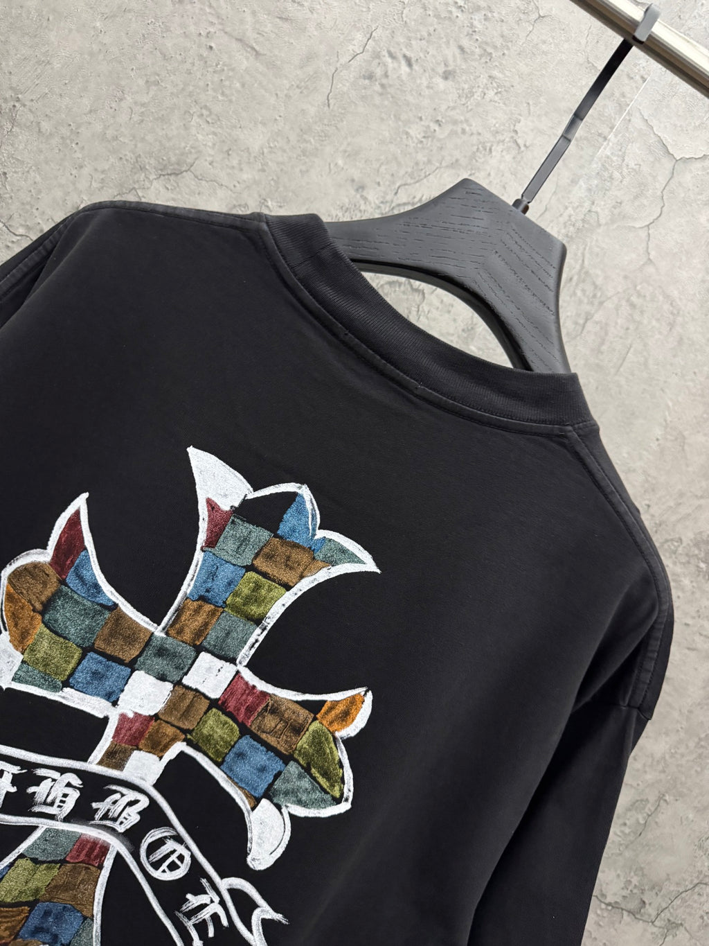 Black short-sleeve T-shirt with partial multicolor cross graphic on chest